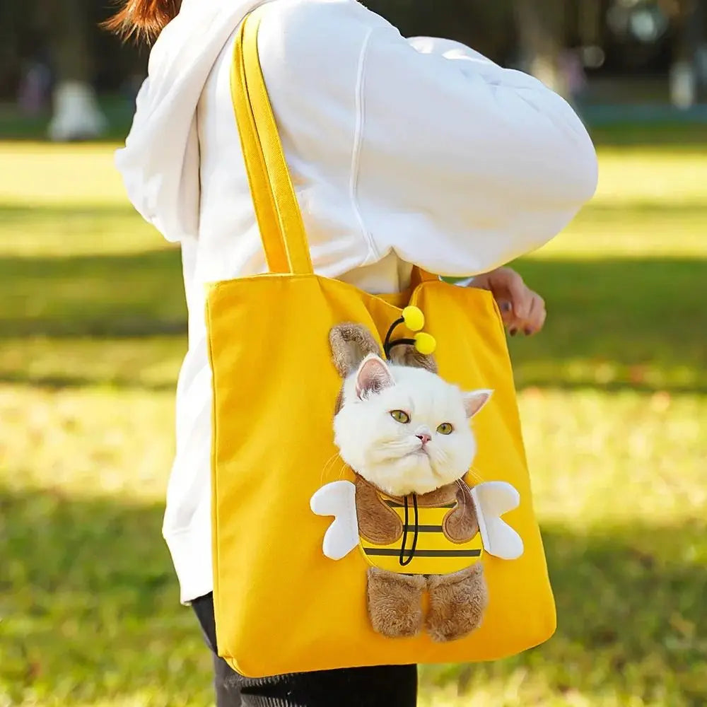 Yellow Bee PeekaBag carried over the shoulder, cat riding head-out