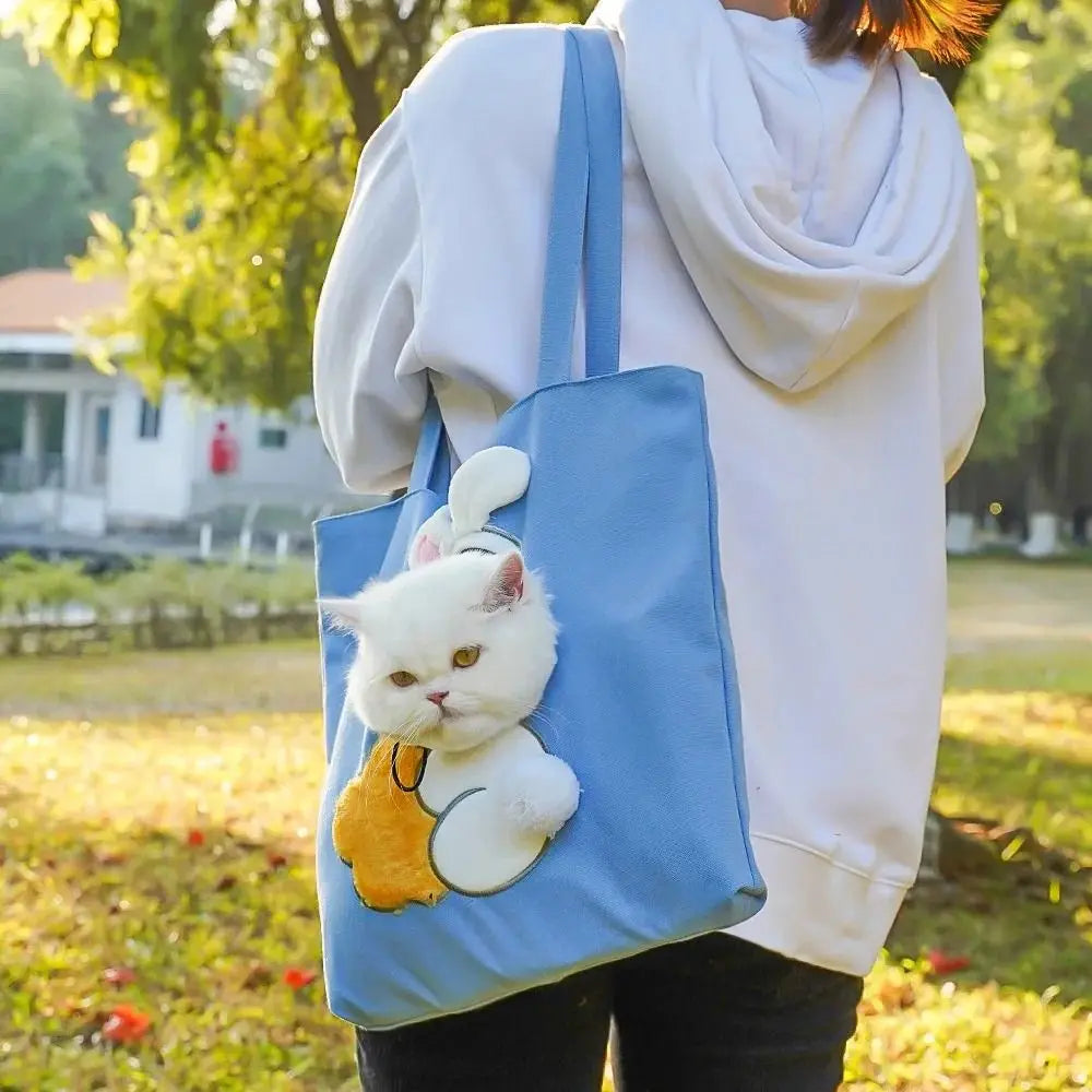 Blue Bunny PeekaBag tote worn over one shoulder with a cat in the bunny costume