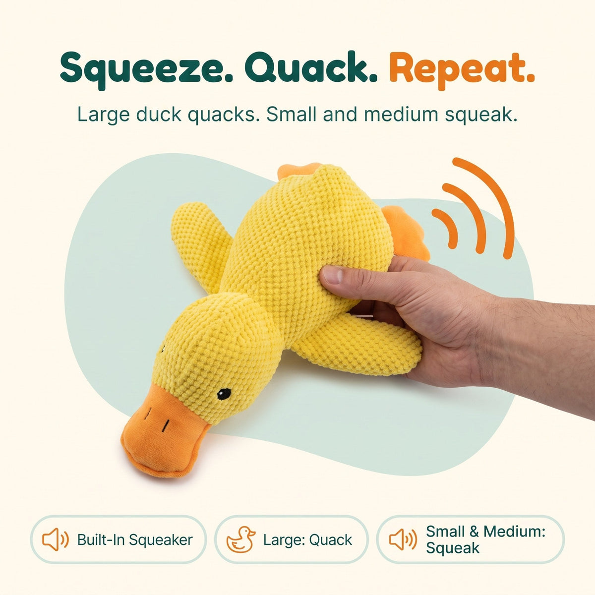 Hand squeezing the Wuffy SnoozeDuck plush duck dog toy to set off its built-in squeaker