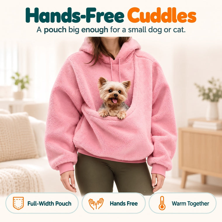 Woman wearing the pink Wuffy SnuggleHood pet hoodie with a small dog resting in the full-width front pouch